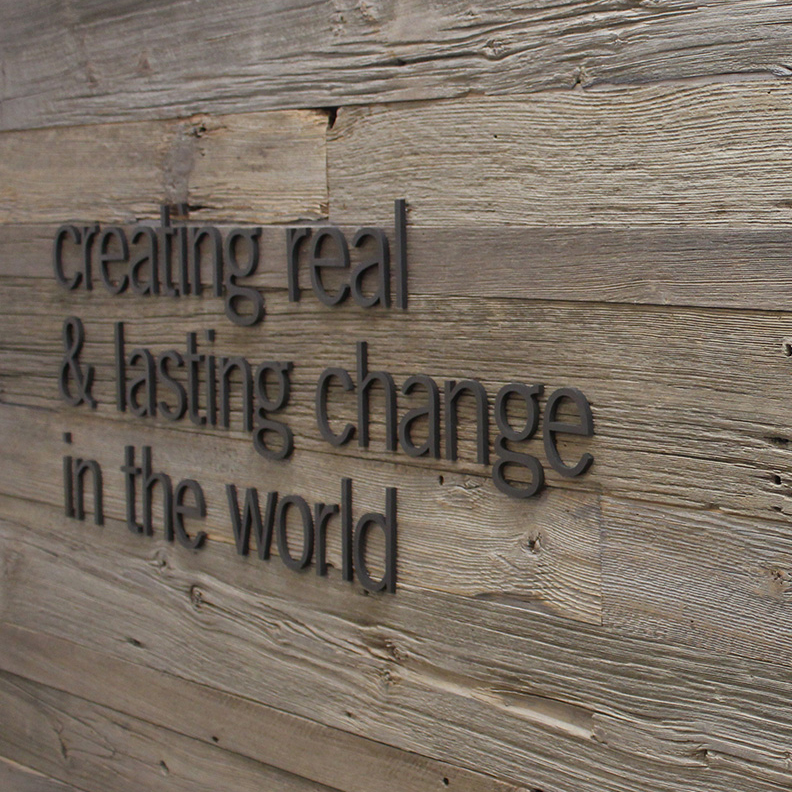 GMMB's office wall saying "creating real & lasting change in the world"